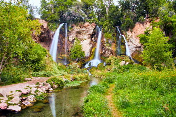 istock Beautiful triple waterfalls in lush forest with simple walking path and river 1490079767
