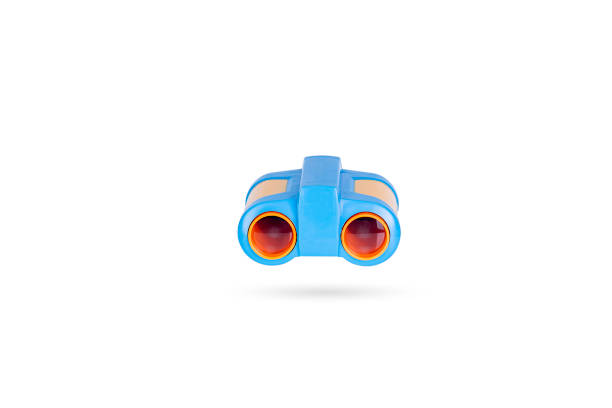 Little boy holding a binocular at park.