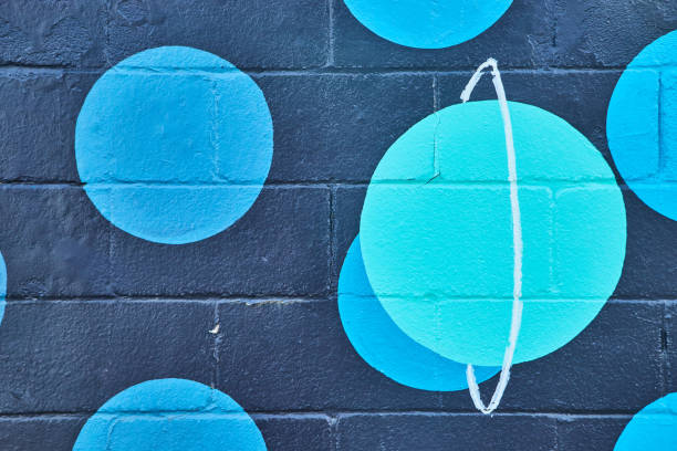 istock Black cement painted wall with blue spots and teal planet 1490080243