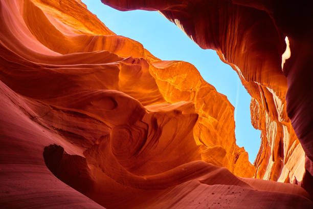 istock Blue sky visible from the bottom of an orange canyon 1490080475