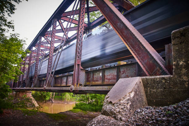 istock Blur of train passing through large metal bridge 1490081700