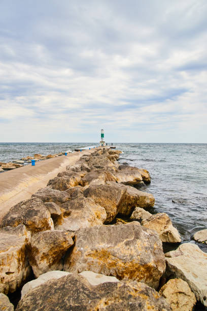 istock Boulders next to cement pier by lake 1490081840