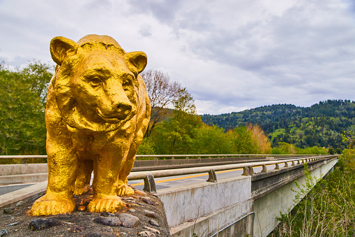Image of Bridge marked with giant gold bear statue at entrance