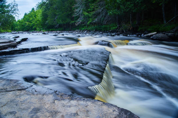istock Cascading faint blue waterfalls against rocky ledge 1490082430