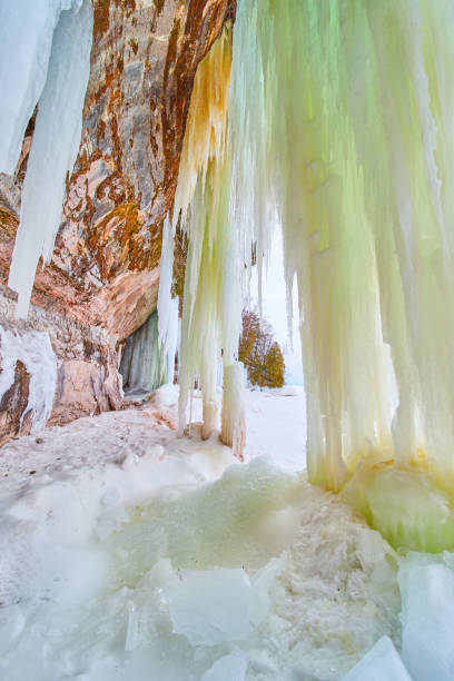 istock Cliff rocks with sheets of green ice from ground to ceiling 1490083363