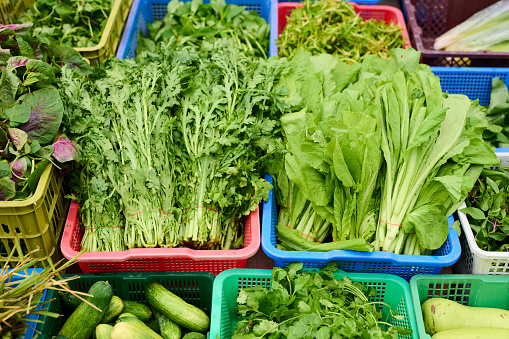 A Selection of Mixed Cabbages For Sale on a Market Stall