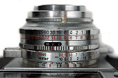 Close up of Ricoh 500 camera lens with adjustment numbers in black and red