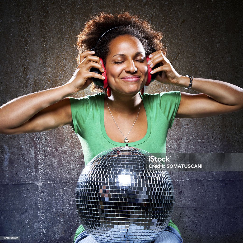 Funky Girl Listening to Music with Read Headphones Adult Stock Photo