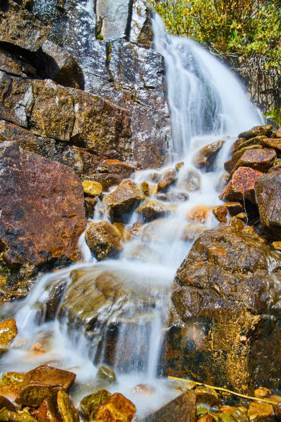 istock Close-up view of small waterfall over red and brown rocks 1490083982