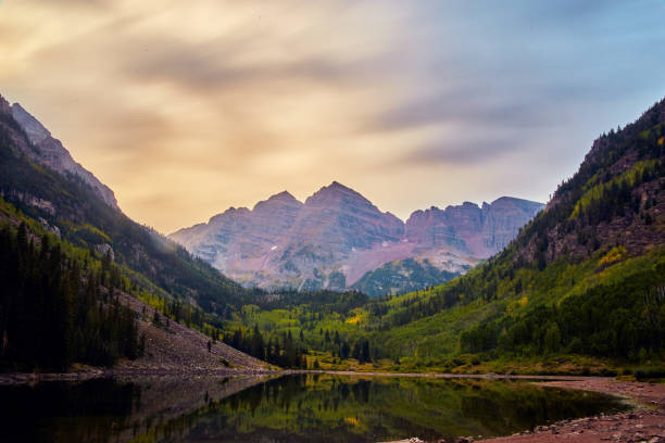istock Cloudy sunrise view of majestic Maroon Bells mountain range 1490083998