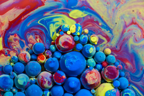 istock Cluster of acrylic paint orbs floating on rainbow surface 1490084004