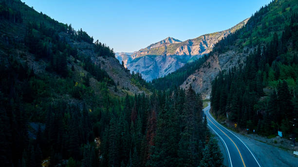 istock Dangerous road winding through the mountain valley on the edge 1490085464