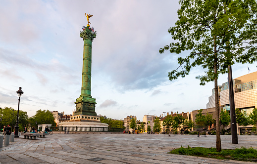 Paris, France. 7 May 2023. The July Column from 1830, in Place de la Bastille in Paris at dusk with people walking the area.