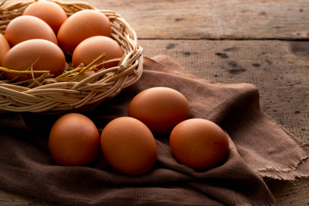 istock Close up Chicken eggs on wooden plate 1490085734