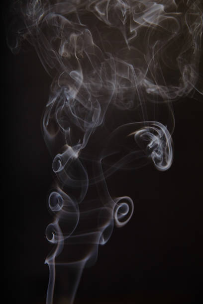 istock Delicate curling gray smoke on a black background 1490085792