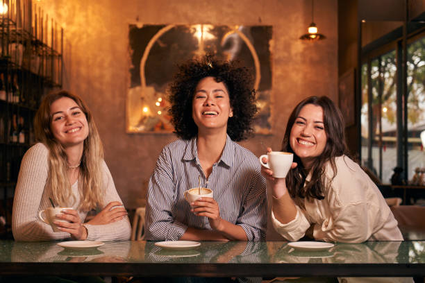 istock Portrait three friends pose smiling for photo while spending free time having a drink at coffee shop. 1490086985