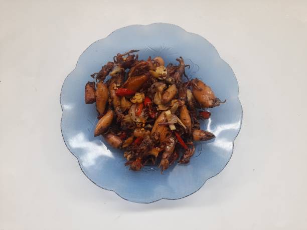 istock stir fried squid on plate top view on white background. 1490088071