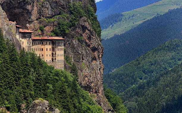 Aerial cliffside shot of Sumela Monastery in Trabzon, Turkey The Virgin Mary Monastery (The Sumela Monastery) stands at the foot of a steep cliff facing the Altındere valley in the region of Maçka in Trabzon Province,Turkey. monastery stock pictures, royalty-free photos & images