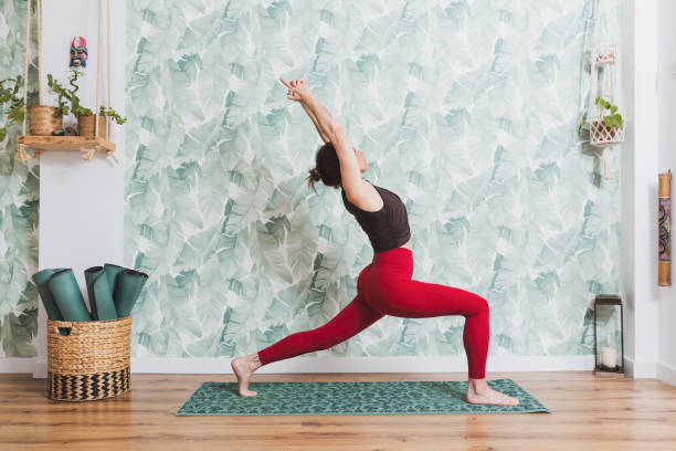 Yoga trainer doing yoga indoor class. stock photo