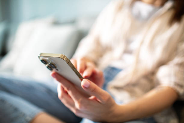 istock Young woman using a smart phone at home 1490092024
