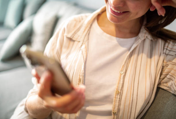 istock Young woman using a smart phone at home 1490092104
