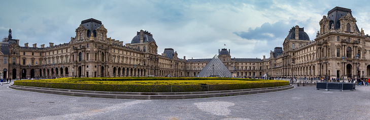 PARIS, FRANCE - April 24, 2023: A scenic panoramic view of the Louvre Museum at the heart of Paris, Famous historical art landmark in France, Europe