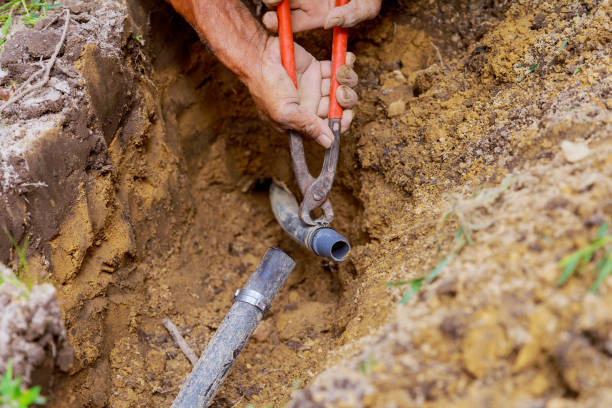 istock The man is working with pipes in the ground while installing an underground sprinkler system to water the garden in the yard 1490094503