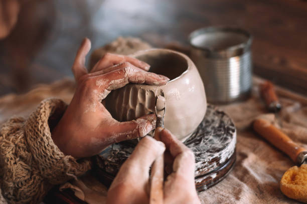 istock Female sculptor making clay mug in a home workshop,hands close-up.Small business,entrepreneurship,hobby, leisure concept 1490095005
