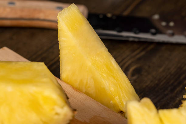 ripe yellow pineapple cut into pieces, delicious and fresh pineapple cut into pieces during cooking