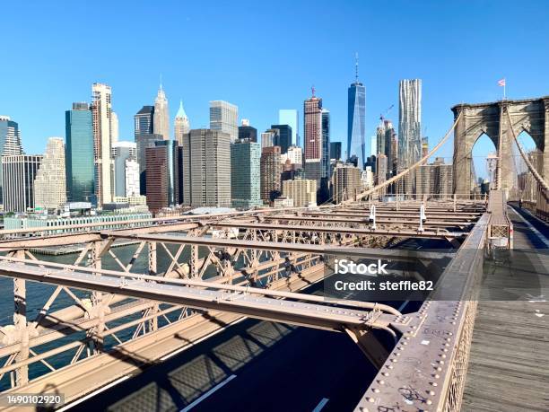 View Over Manhattan Skyline From Brooklyn Bridge New York Stock Photo - Download Image Now