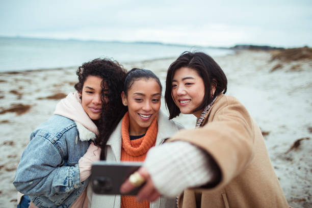 istock Three young women taking a selfie on a beach 1490103311