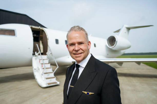 istock Corporate jet pilot standing on airport tarmac 1490103612