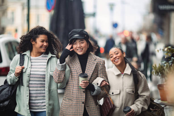 istock Three young women walking down a street in a town 1490103666