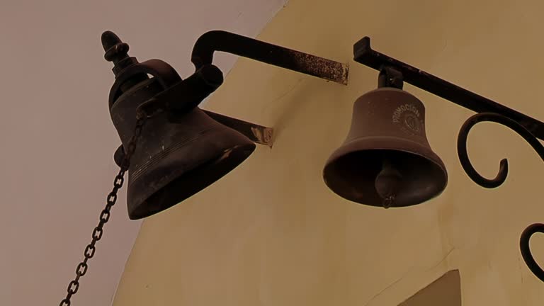 Old Bells Mounted on a Wall inside an Old School in Argentina. Close Up.