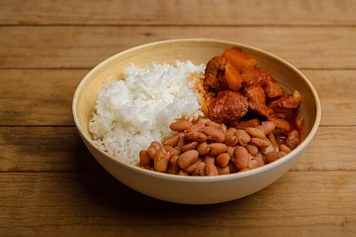 Brazilian typical lunch, rice and brown beans plate.