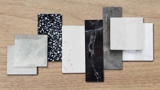 istock close up of interior premium stone  samples including black marble, grey artificial stone, terrazzo tiles placed with floor tiles. counter top samples on wooden table background. 1490106496