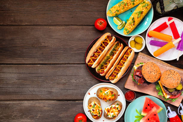 istock Summer BBQ food side border over a dark wood background 1490106680