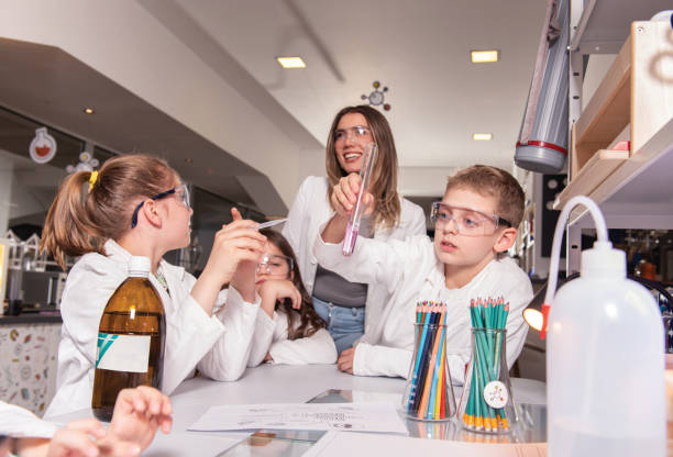istock Diverse schoolchildren with teacher work together on science project 1490107583