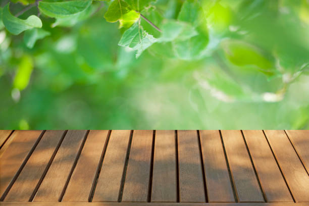 istock wooden table with pink flowers background 1490107593
