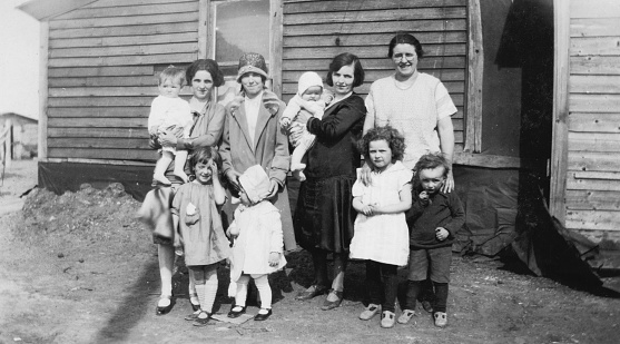 Saskatoon, Saskatchewan, Canada - 1929. Group of four mothers with their children at the city of Saskatoon in Saskatchewan, Canada. Vintage photograph ca. 1929.