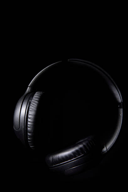 istock Wireless headphones still life in low key lighting. 1490117611