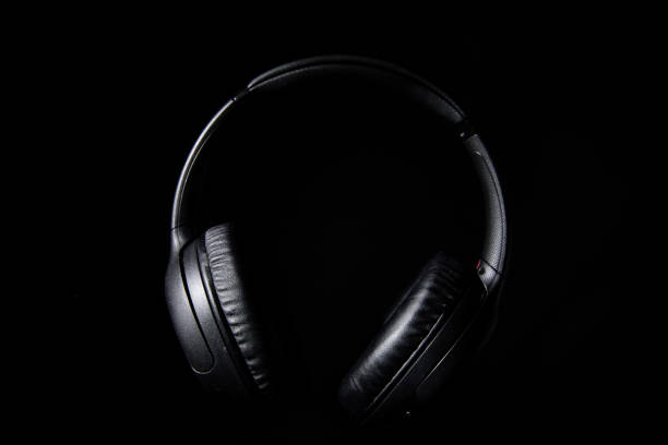 istock Wireless headphones still life in low key lighting. 1490117629