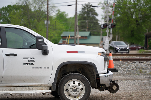 Grand Junction, Tennessee - April 29, 2023: Norfolk Southern work truck parked by train track crossing in Grand Junction, Tennessee.