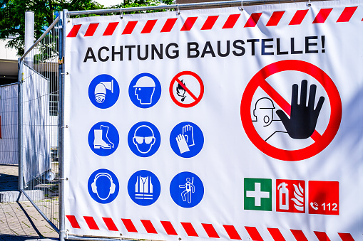 men at work sign in germany - translation: danger, construction site!