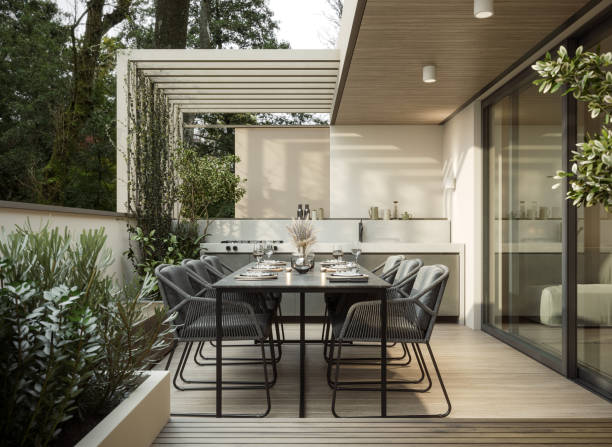 Modern home terrace. Luxury outdoor table with chairs and built in barbeque. Interior design.