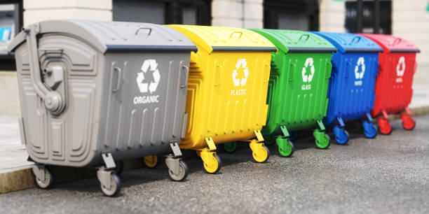 istock Garbage containers with separated garbage on a street. Trash bins for plastic, glass, paper and organic. Segregate waste and garbage recycling concept. 1490123542