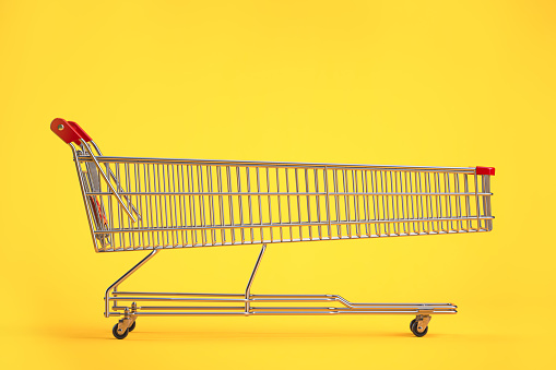 Long shopping cart on yellow background. Sales an discounts concept. 3d illustration