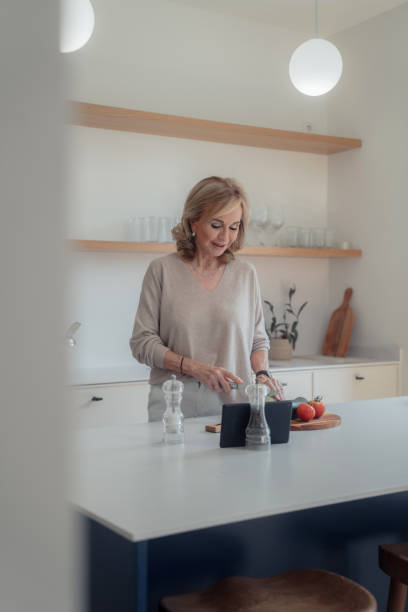 istock Mature woman preparing food 1490123735