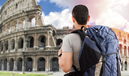 Traveler boy in europe and looking at the Eiffel Tower in France with backpack and back