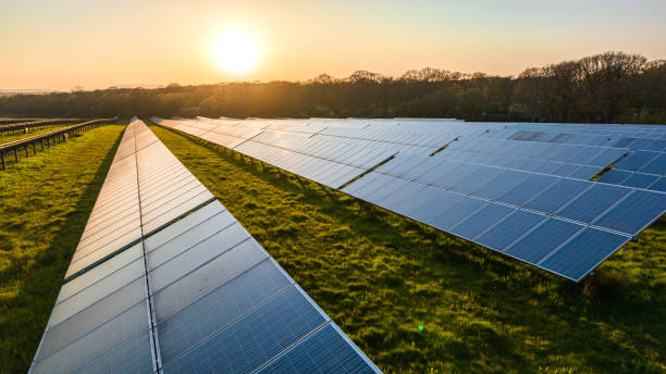 Solar power farm in the evening. Solar power farm in the evening, West Sussex, UK. renewable energy stock pictures, royalty-free photos & images